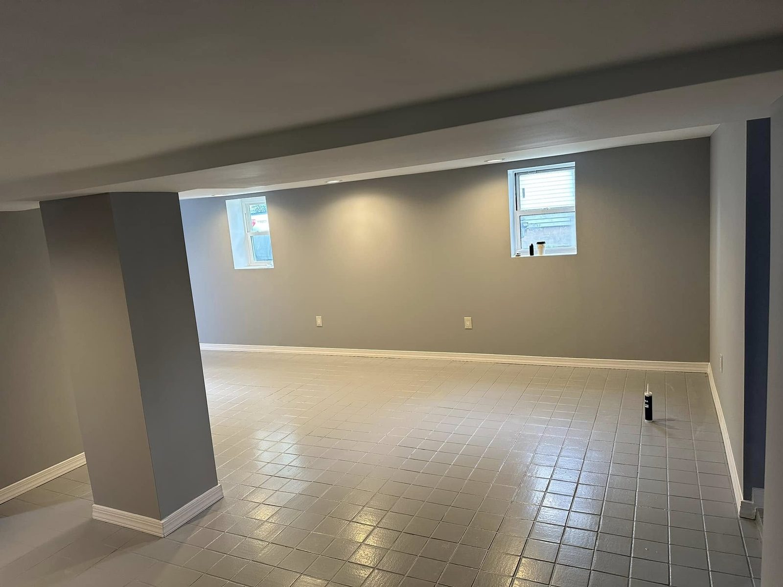 Finished basement with fresh paint and tile floor