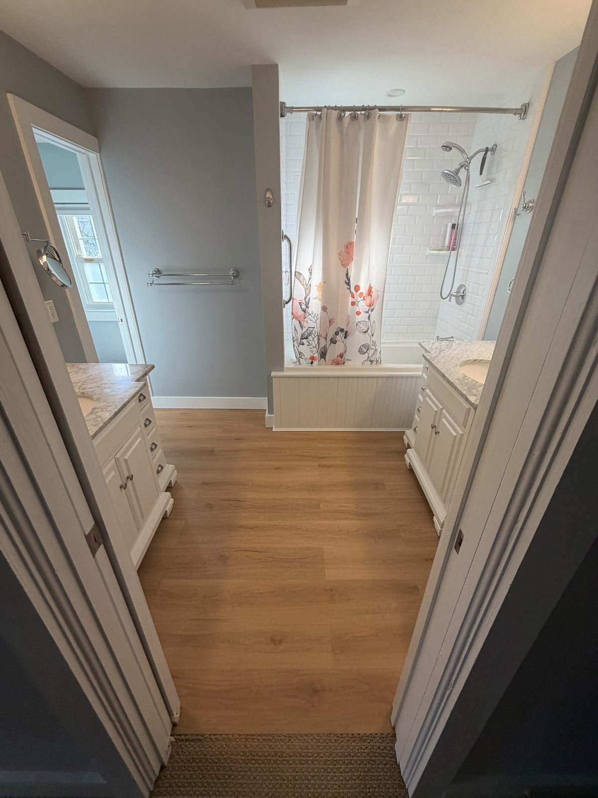 Bathroom remodel with new flooring and tiled tub surround